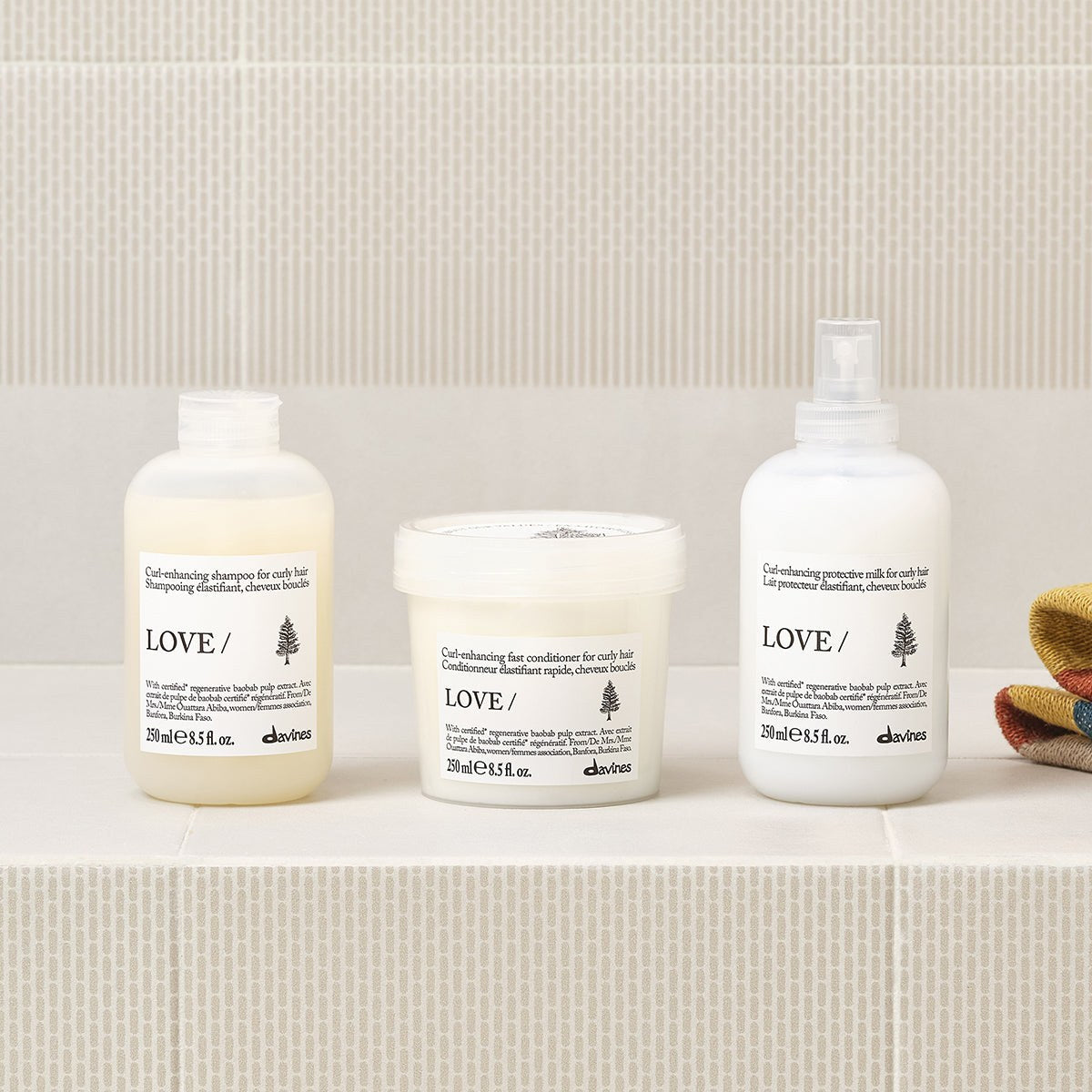 Davines LOVE Curl Shampoo with the LOVE Curl range on a bathroom shelf