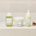 Davines MOMO Moisturizing Conditioner with the MOMO range on a bathroom shelf