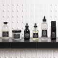 Davines OI Shampoo with the OI range on a bathroom shelf